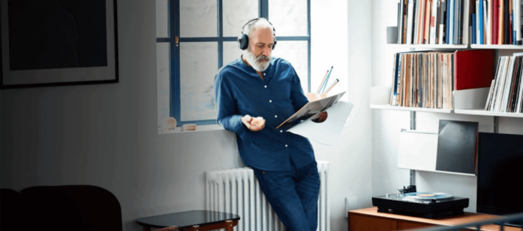 Old Man With Headphones Reading